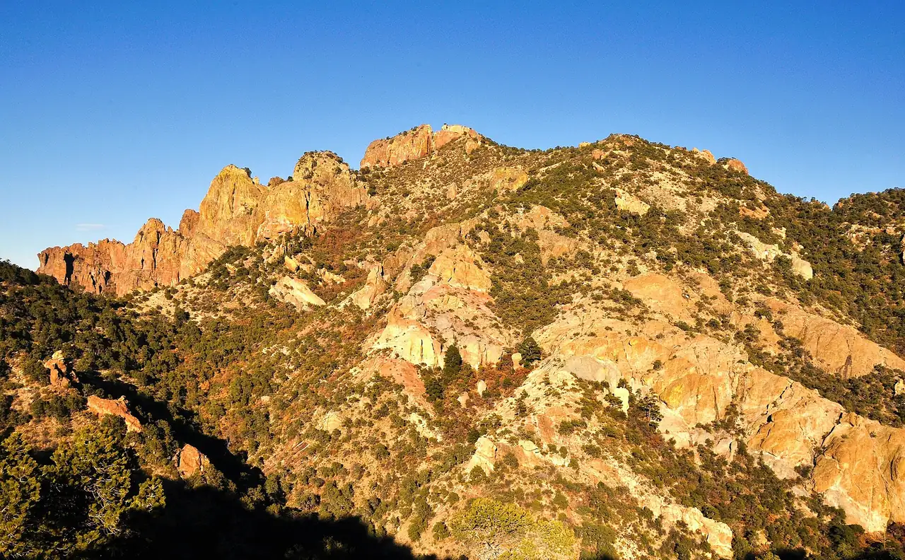 Rocky orange peaks and green shrubs seen from the Lost Mine Trail