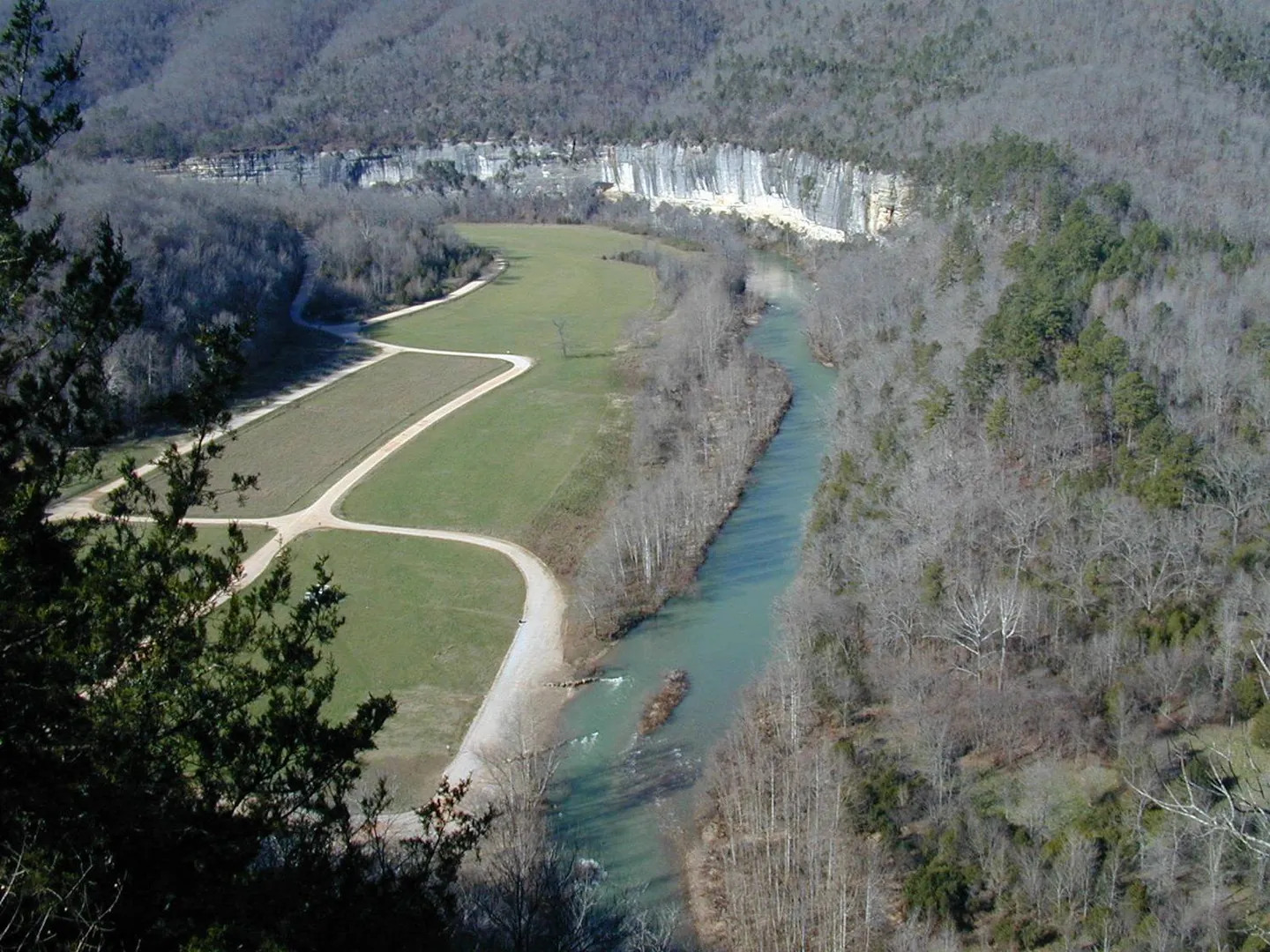 Looking down on the grassy Steel Creek valley, its gravel road and the Buffalo River, with Roark Bluff beyond, in winter